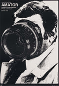 Black and white movie poster for Amator (Camera Buff) showing a man's face mostly obscured by a large, dramatic camera lens, 1979 Polish design.