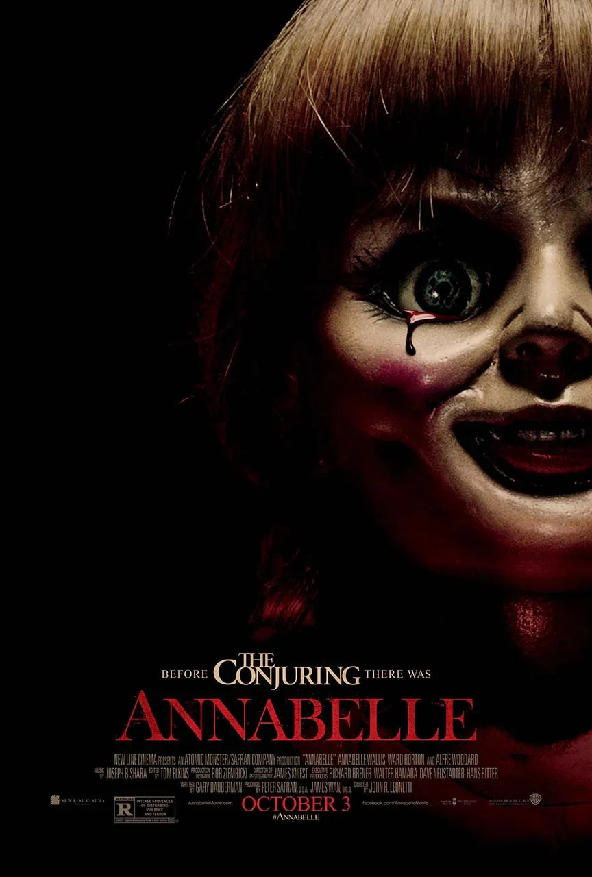 Close-up promotional movie poster for Annabelle (2014), showing the unsettling doll with a blood tear and wide, menacing smile against a black backdrop.