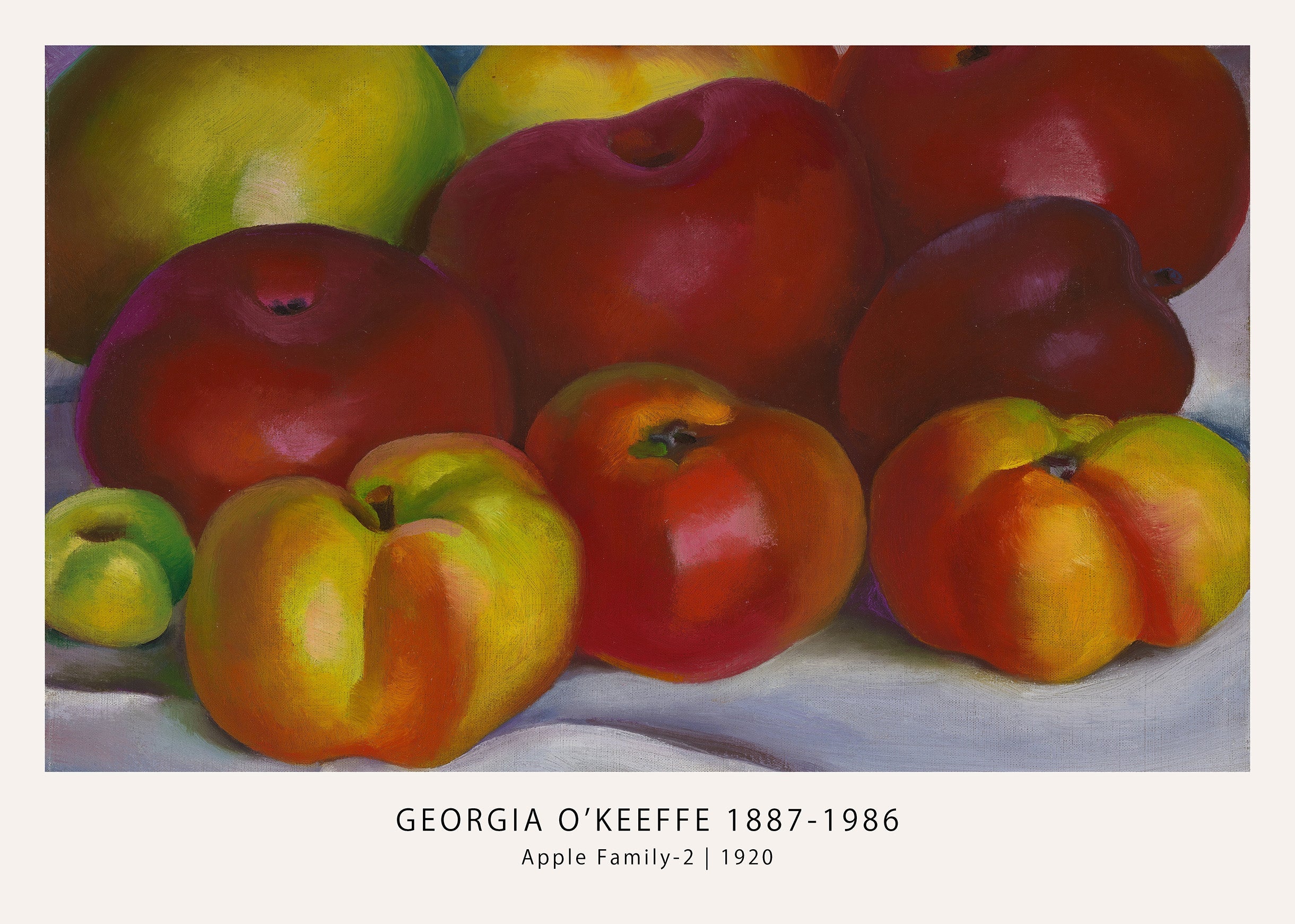 Georgia O'Keeffe's 1920 still life painting, "Apple Family-2," featuring an intimate cluster of red, yellow, and green apples on a white cloth.