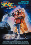 Theatrical poster for Back to the Future Part II showing Marty McFly and Doc Brown posing dramatically in front of the flying Delorean time machine engulfed in electrical energy.