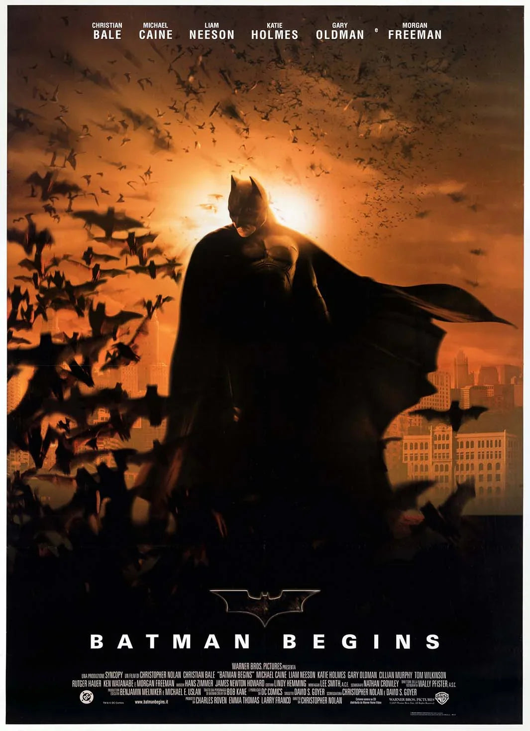 Iconic Batman Begins movie poster featuring Christian Bale's Dark Knight silhouette against an orange skyline, surrounded by a swarm of flying bats.