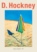 Iconic David Hockney painting poster featuring a multi-colored beach umbrella casting a deep blue shadow on textured sand.