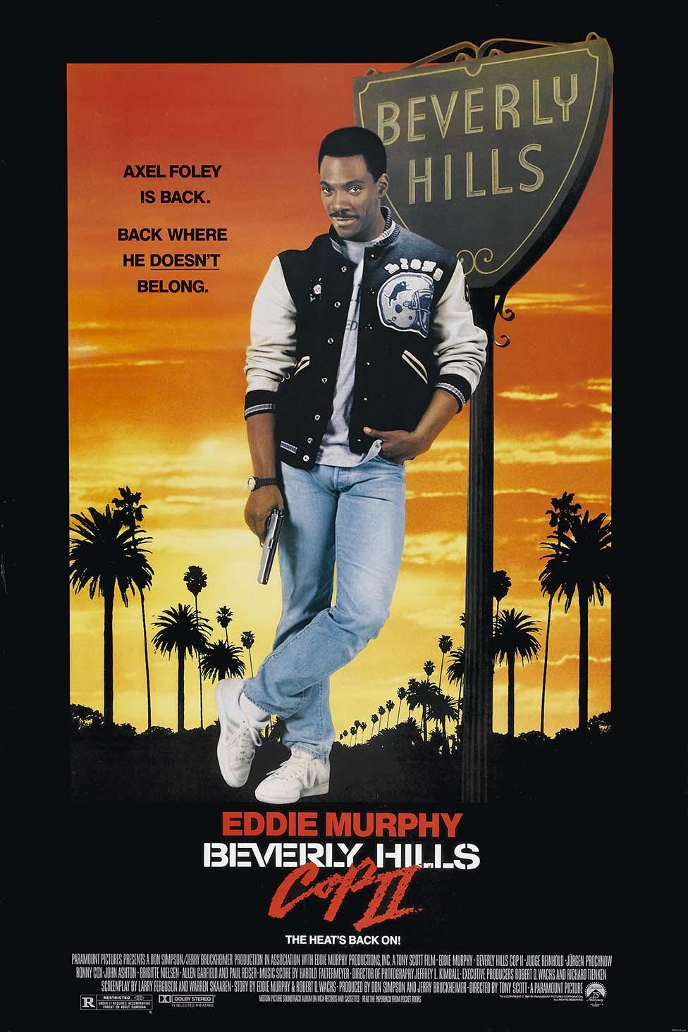 Eddie Murphy as Axel Foley in the original Beverly Hills Cop II movie poster, leaning by the Beverly Hills sign during a dramatic orange sunset.