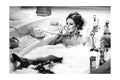 Brigitte Bardot relaxing in a bubble bath while talking on a vintage rotary phone, surrounded by perfume bottles