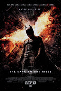 Official Dark Knight Rises movie poster showing Batman standing centered while Gotham City collapses and explodes behind him in fiery orange light.