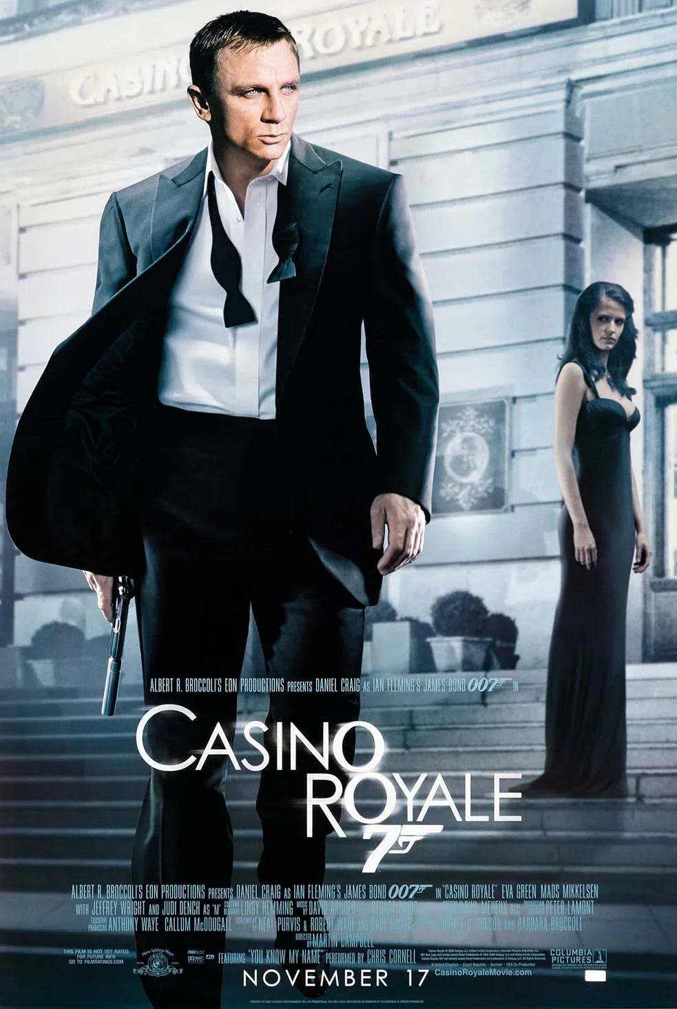 Daniel Craig as James Bond in a tuxedo holding a gun next to Eva Green in a black dress on the original Casino Royale movie poster.