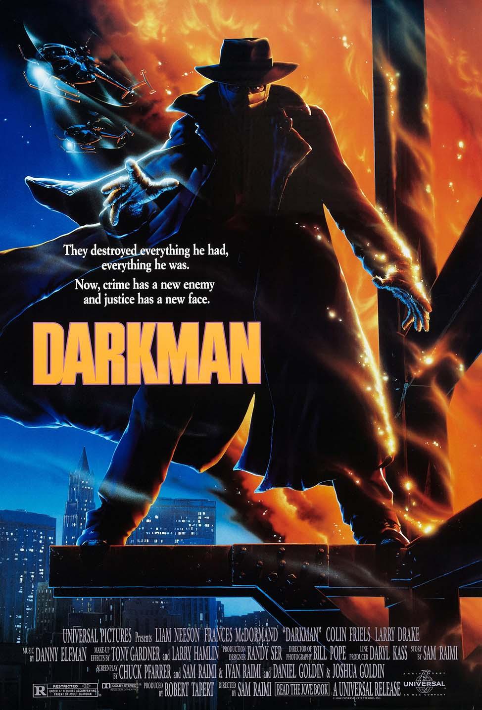 Original theatrical movie poster for Darkman (1990) showing the protagonist in a trench coat and fedora against a fiery orange skyline above a city.