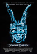 Original movie poster for Donnie Darko featuring a blue spectral image of Frank the Rabbit's mask created from the faces of the main cast against a black background.