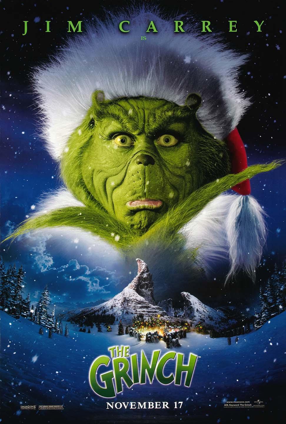 Official movie poster for The Grinch (2000) showing a large close-up of Jim Carrey as the Grinch over a snowy depiction of Whoville.