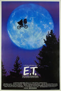 Original E.T. The Extra-Terrestrial movie poster showing Elliott and E.T. flying a bicycle in silhouette against a large blue moon.