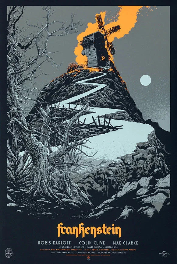 Dark hilltop with a spooky windmill under an orange sky, barren twisted trees, and rocky path in Frankenstein movie poster