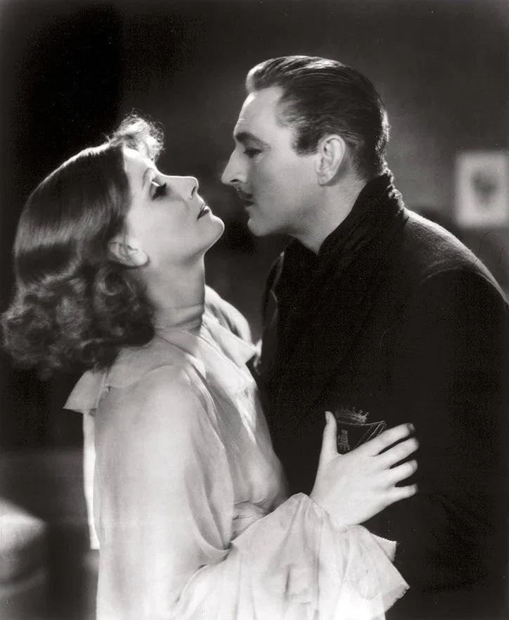 Black and white vintage portrait of a man and woman in an intimate pose, classic Hollywood glamour style