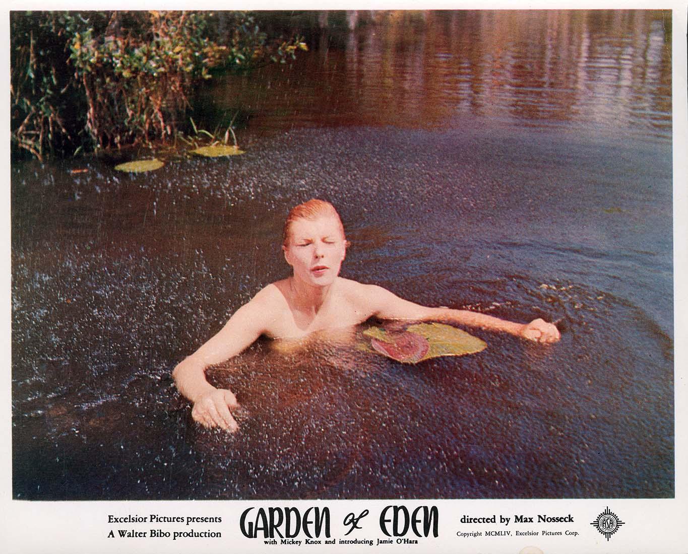 Vintage lobby card for the 1954 movie Garden of Eden showing actress Jamie O'Hara partially submerged in dark water with a lily pad.