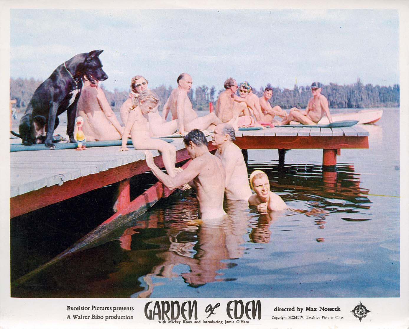 Vintage lobby card for the 1954 film Garden of Eden showing a group of naturists, including a dog, relaxing on a dock by the water.