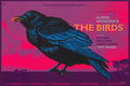 Alfred Hitchcock's The Birds movie poster featuring a large blue-black crow against a red and purple sky at sunset