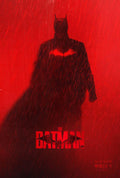 Official movie poster for The Batman (2022) showing the dark silhouette of Batman in the red rain with the glowing bat symbol and movie title.
