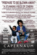 Official Capernaum movie poster showing the young protagonist, Zain Al Rafeea, and a baby sitting on concrete steps, surrounded by critical acclaim quotes.