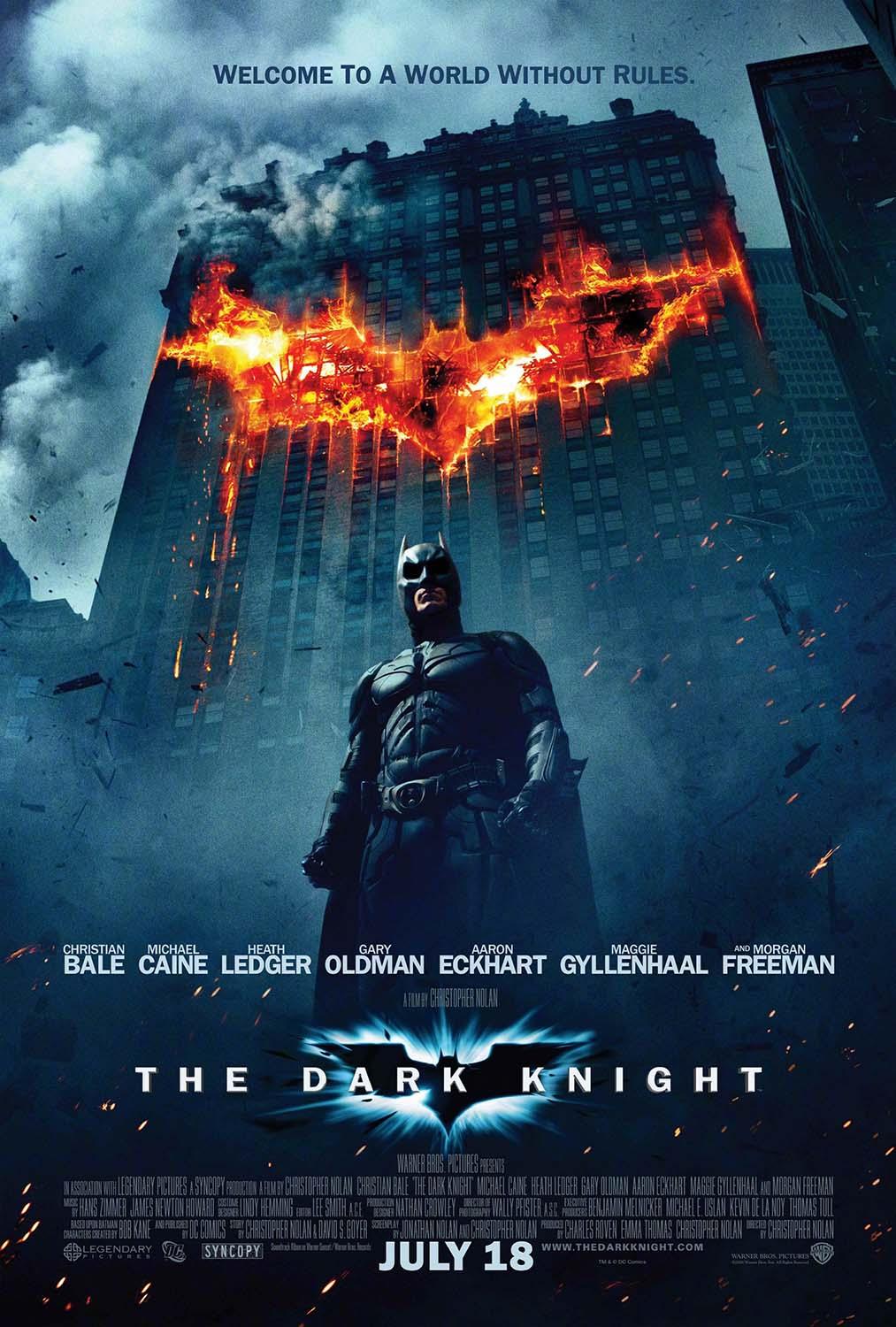 The Dark Knight movie poster featuring Batman standing against a towering skyscraper engulfed in fire shaped like the Bat-symbol, promoting the Christopher Nolan film.