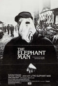 Official black and white theatrical poster for The Elephant Man featuring John Hurt's masked character and Victorian street background.