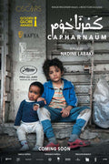 Official Capernaüm movie poster showing lead actor Zain Al Rafeea sitting beside the baby actor, against a distressed urban background, featuring major film festival laurels and awards.