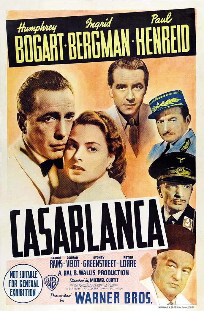 Vintage Casablanca movie poster featuring a montage of Humphrey Bogart and Ingrid Bergman, alongside Paul Henreid and supporting cast members.