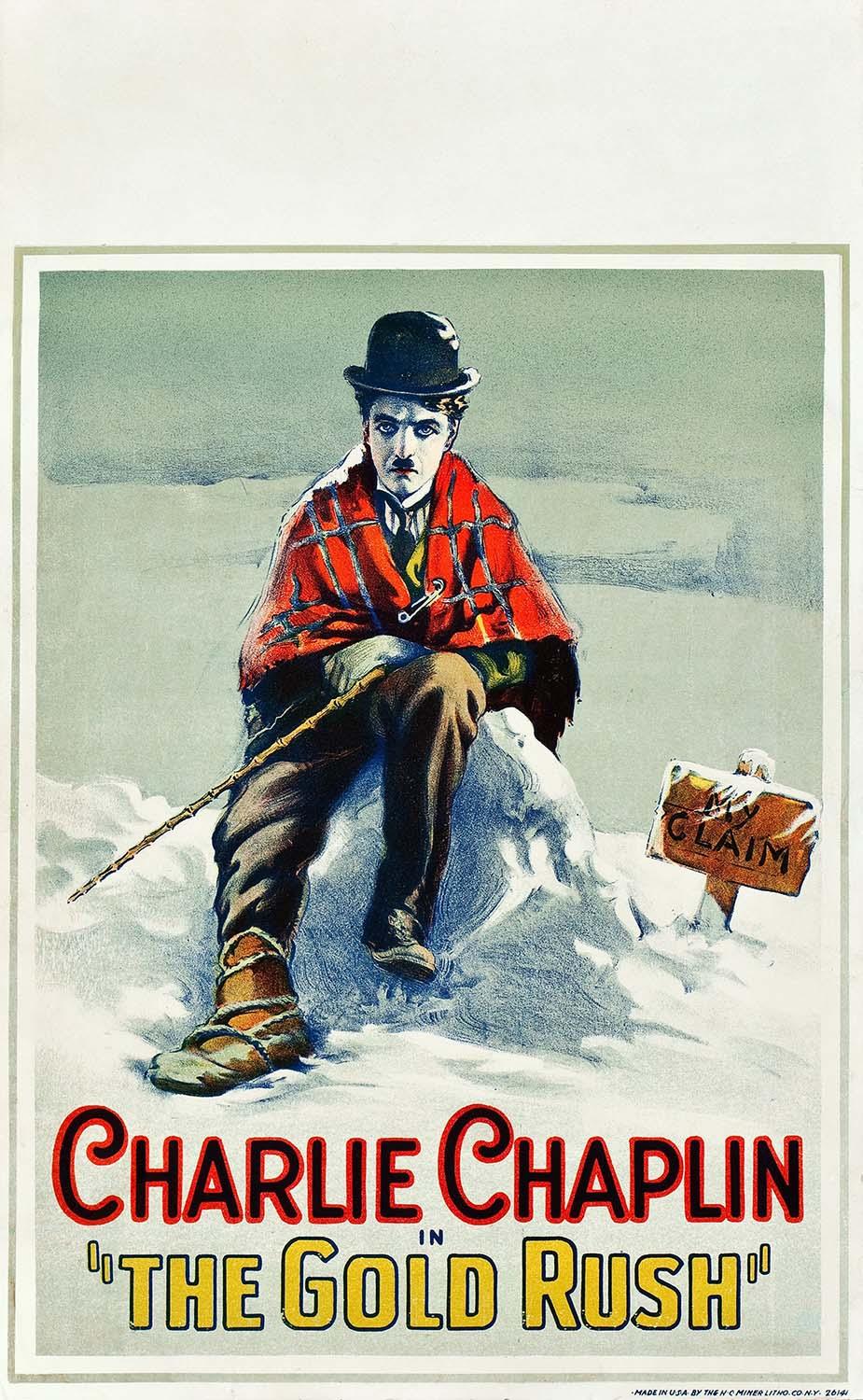 Vintage poster art showing Charlie Chaplin (The Little Tramp) sitting ruggedly in the snow during the Gold Rush, next to a sign marked "My Claim".