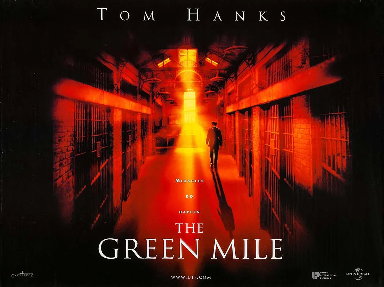 Iconic poster for The Green Mile featuring a prison guard walking down the death row corridor bathed in a powerful orange light, highlighting the film's intense atmosphere.
